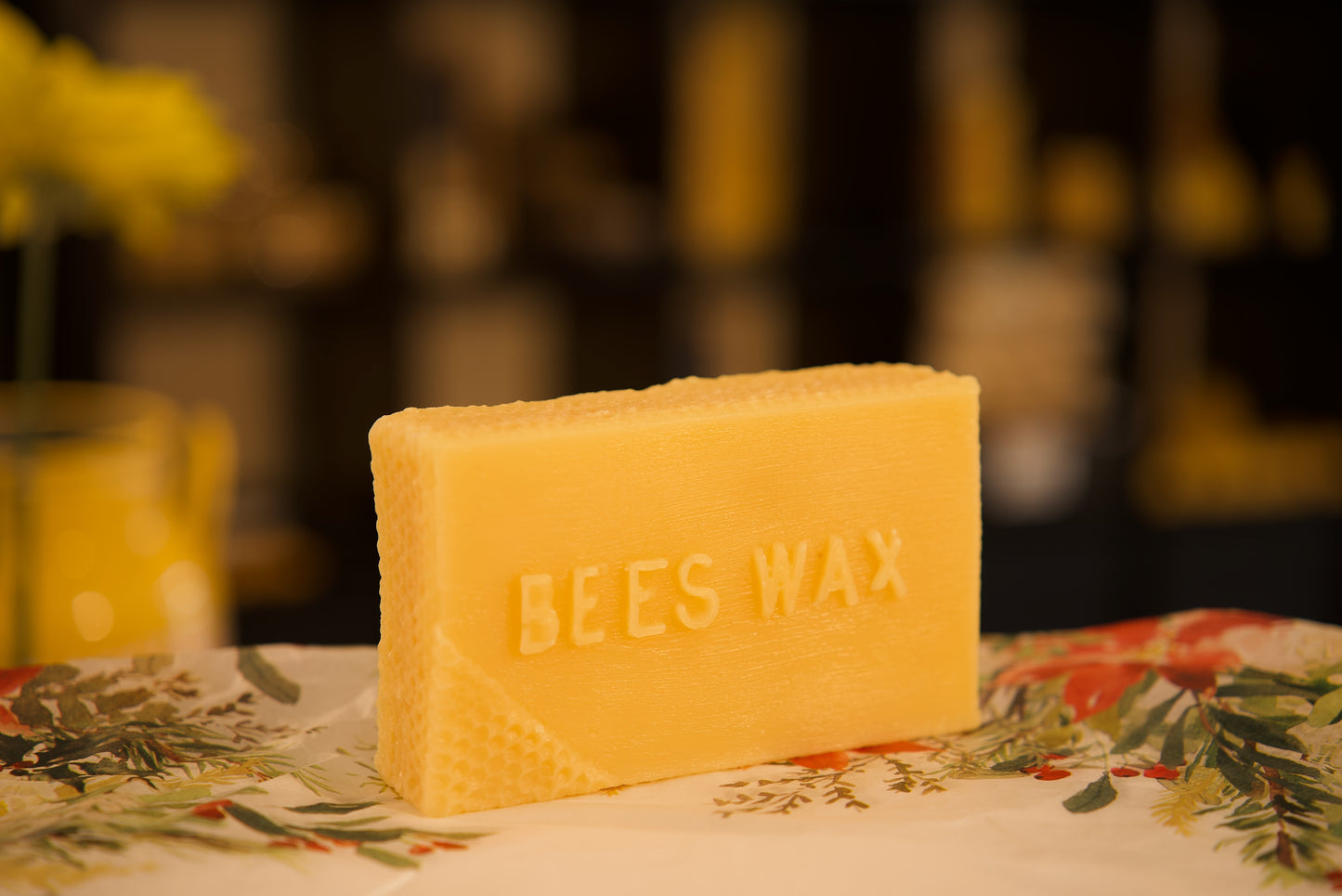 Pure slab of natural beeswax, sculptured into a rectangular shape with wording beeswax on it