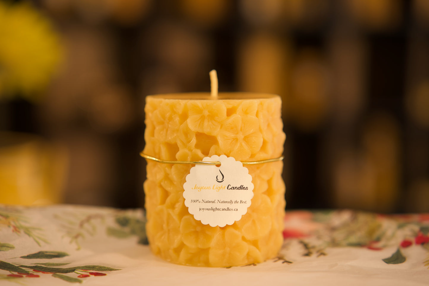 Garden-inspired pure beeswax candle showcasing detailed pansy blooms, sustainable, 3x3.5 inches
