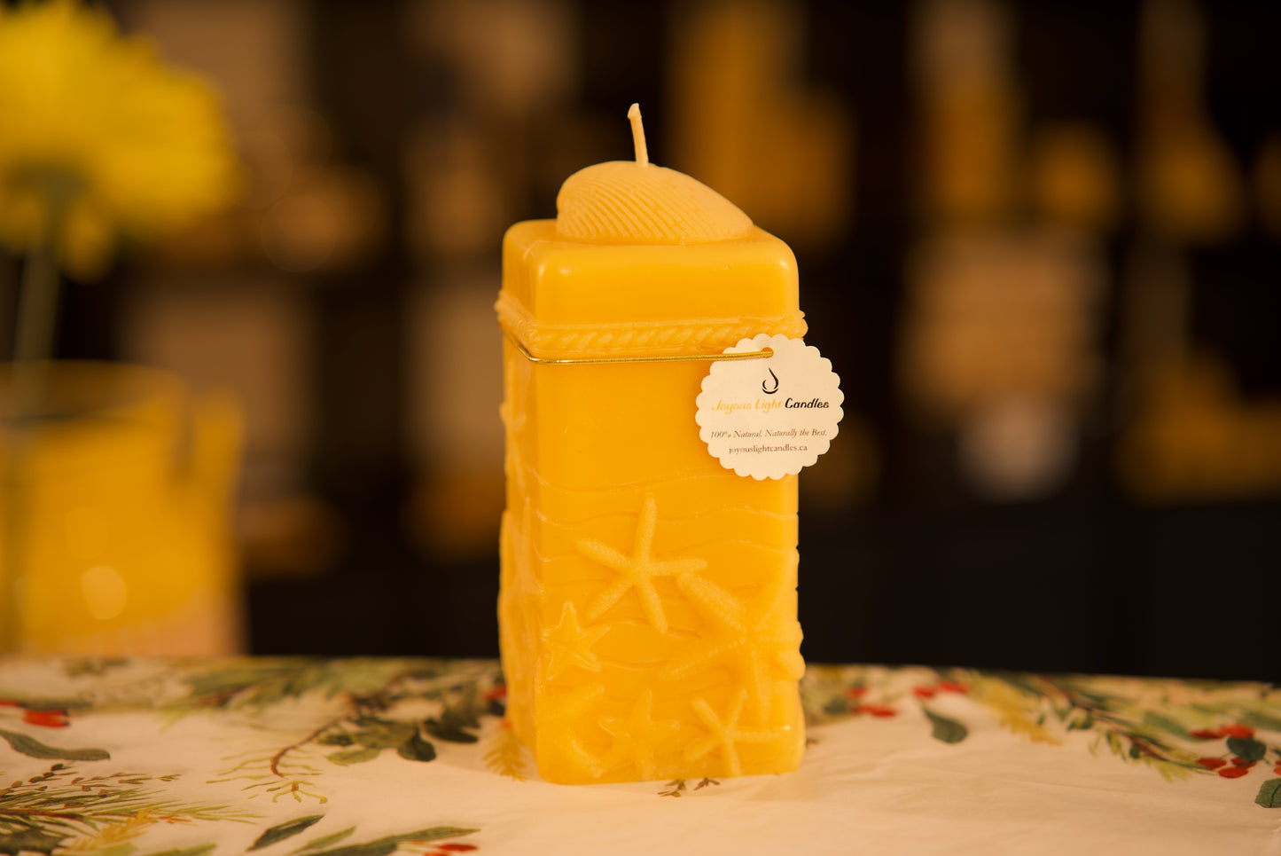 Coastal pure beeswax pillar with embossed starfish design, beach-inspired natural decor, 2.625x6.25 inches