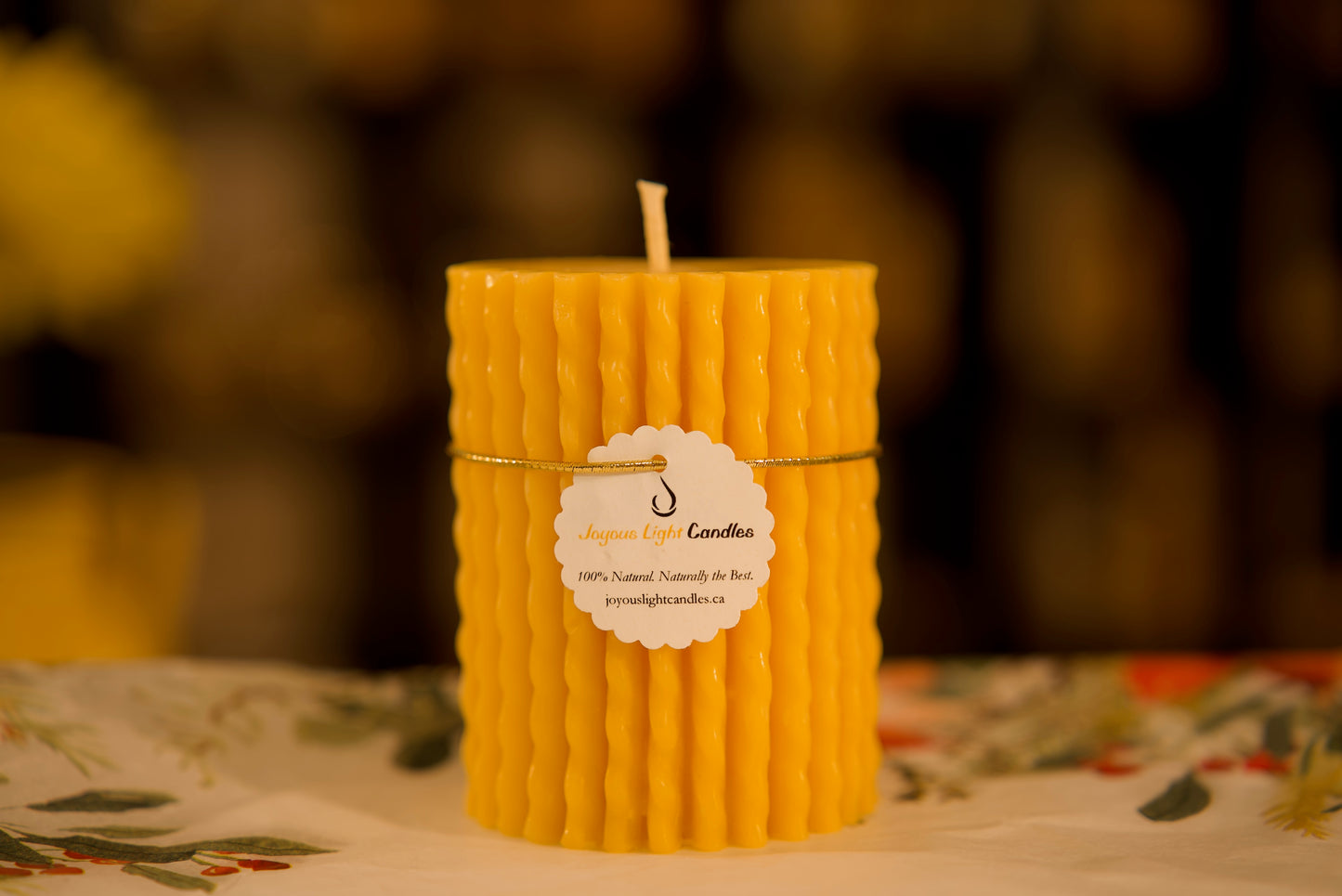 Textured pure beeswax pillar with yarn-inspired pattern, craft-themed decor, 3x3.75 inches