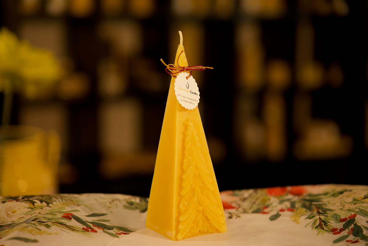 Elegant pyramid-shaped holiday candle in pure beeswax with evergreen motif, 2.5x7.25 inches
