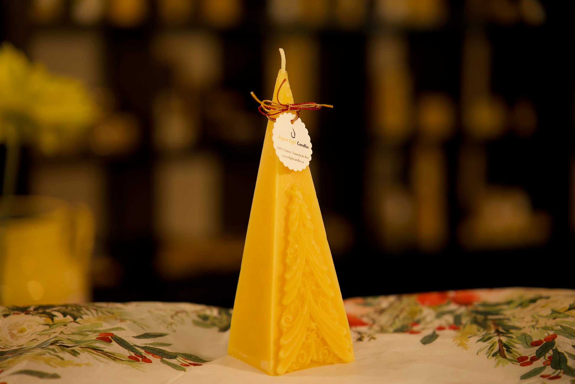 Elegant pyramid-shaped holiday candle in pure beeswax with evergreen motif, 2.5x7.25 inches