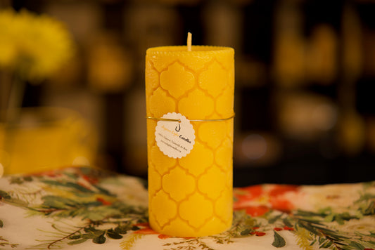 Flowing curved designs grace this eco-friendly beeswax column, 2.75x6 inches