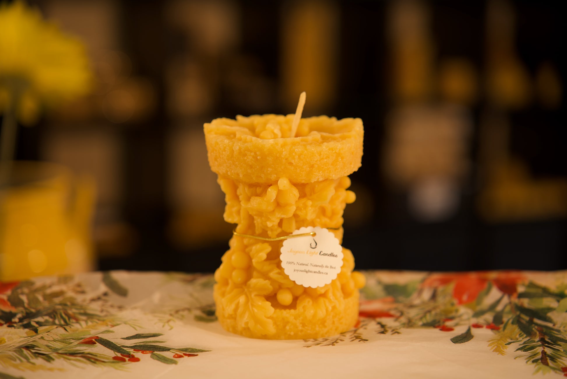 Elegant pure beeswax candle with detailed grape vine design, natural honey scent, 3.25x5 inches